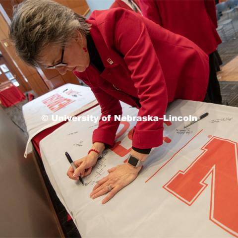 Jane Green, signs one of the four Alumni N150 flags. The flags will travel around the world to various alumni chapters and be signed. They will return in the fall and be hung for homecoming weekend for all to see. Everyone was invited to enjoy a cupcake and join in the festivities with their Husker friends at the Wick Alumni Center, Friday February 15th. The Nebraska Charter was available to view, along with other historical items. Copies of Dear Old Nebraska U could be purchased and signed. Charter Day at the Wick Alumni. February 15th, 2019. Photo by Gregory Nathan / University Communication.